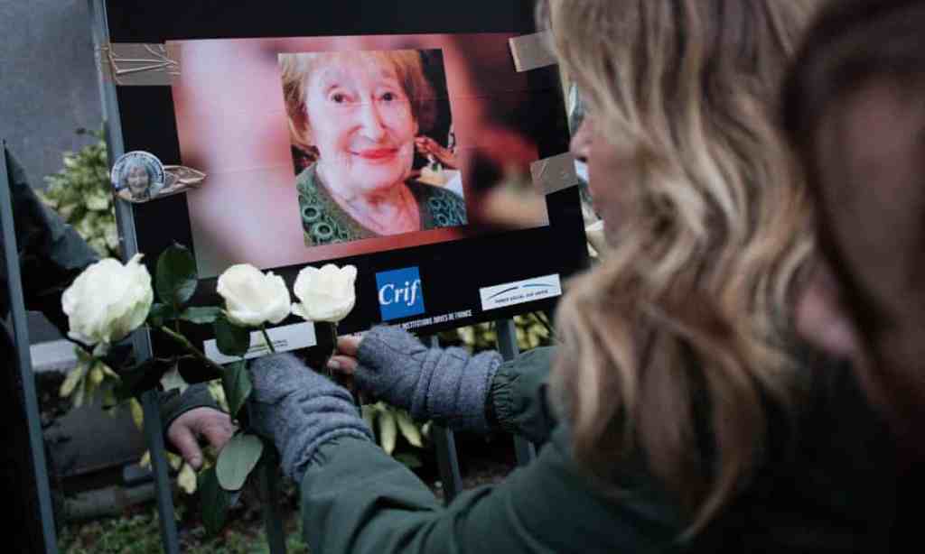 A woman pays tribute to Mireille Knoll outside her home in Paris ,