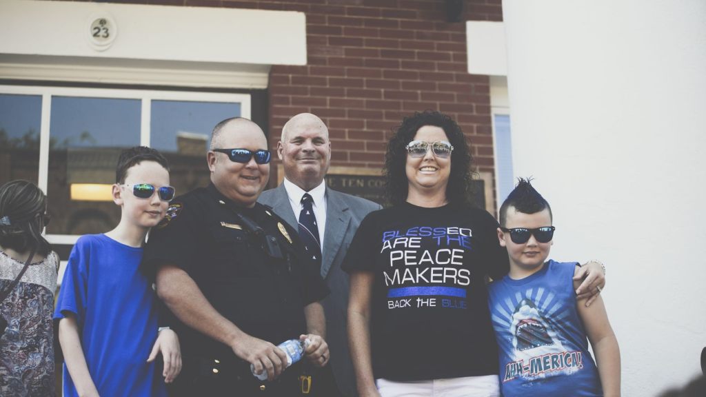 Pastor Perry Cleek pictured with Jonesborough Police Officer, Major Jamie Aistrop and his family during the Independence Day ceremony honoring law enforcement at the Washington County Court House on July 4, 2020.