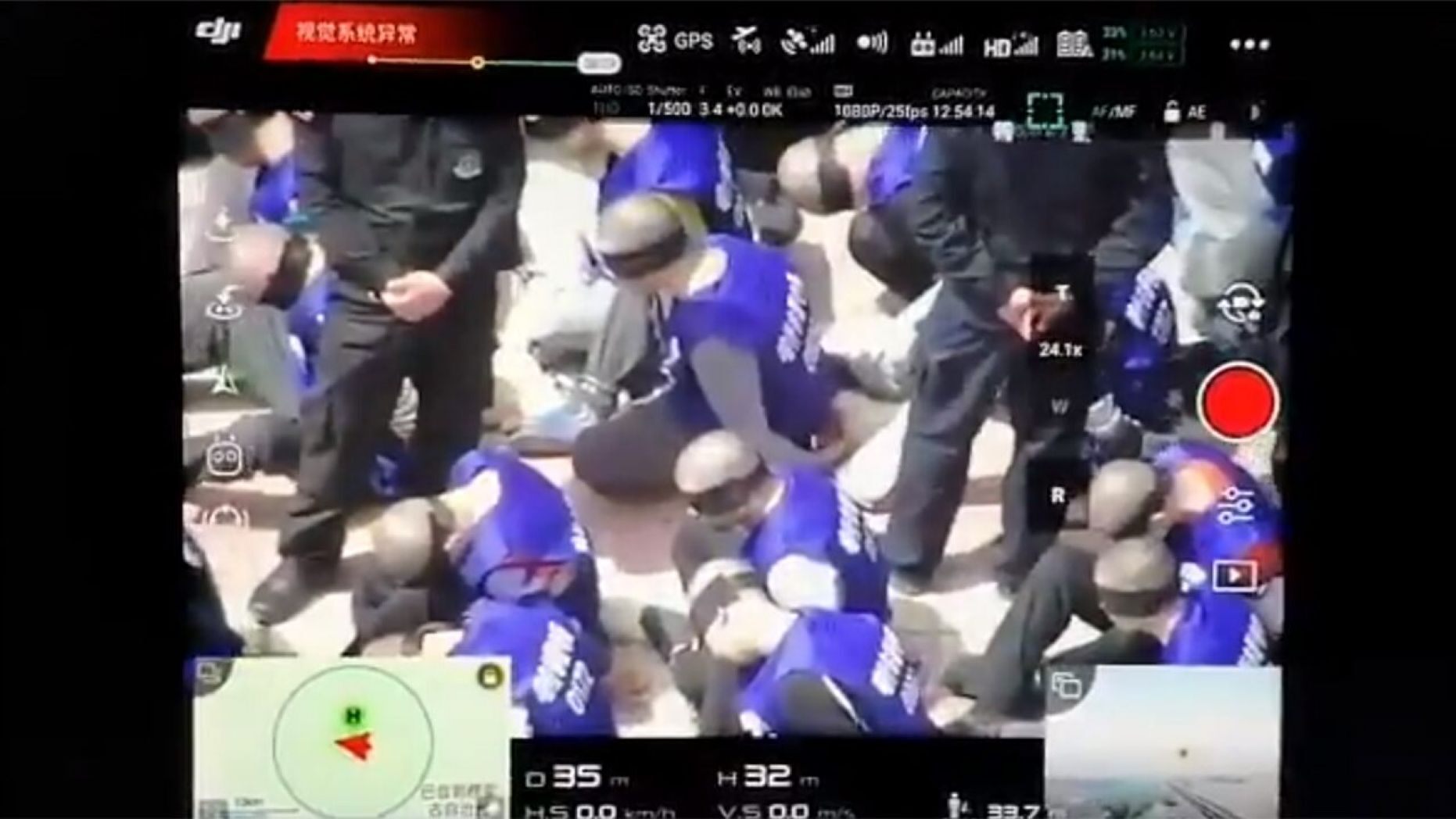 This screenshot purportedly shows hundreds of prisoners shackled and blindfolded who are believed to be from China's minority Uighur Muslims, reports claim.