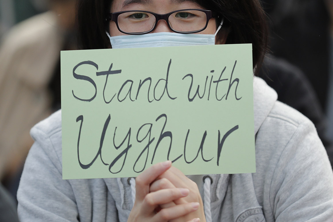 A man holds a sign during a rally to show support for Uighurs and their fight for human rights in Hong Kong, Sunday, Dec. 22, 2019.