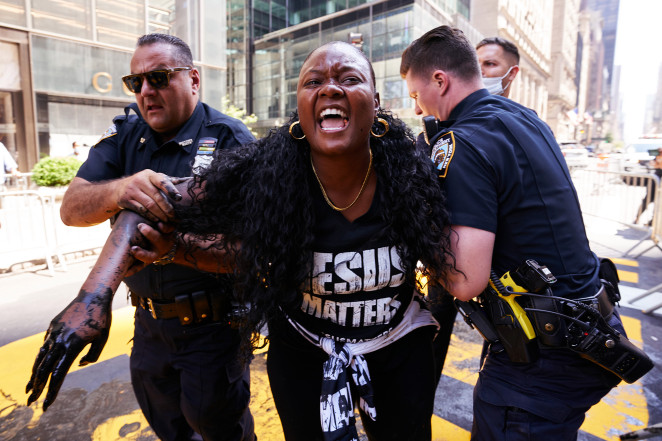 Bevelyn Beatty is detained by NYPD cops after defacing a Black Lives Matter mural at Trump Tower.
