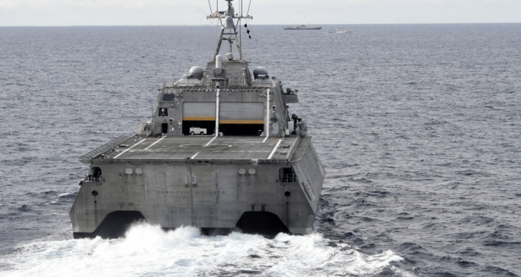 The Independence-variant littoral combat ship USS Gabrielle Giffords (LCS 10), bottom, conducts routine operations in the vicinity of the Chinese vessel