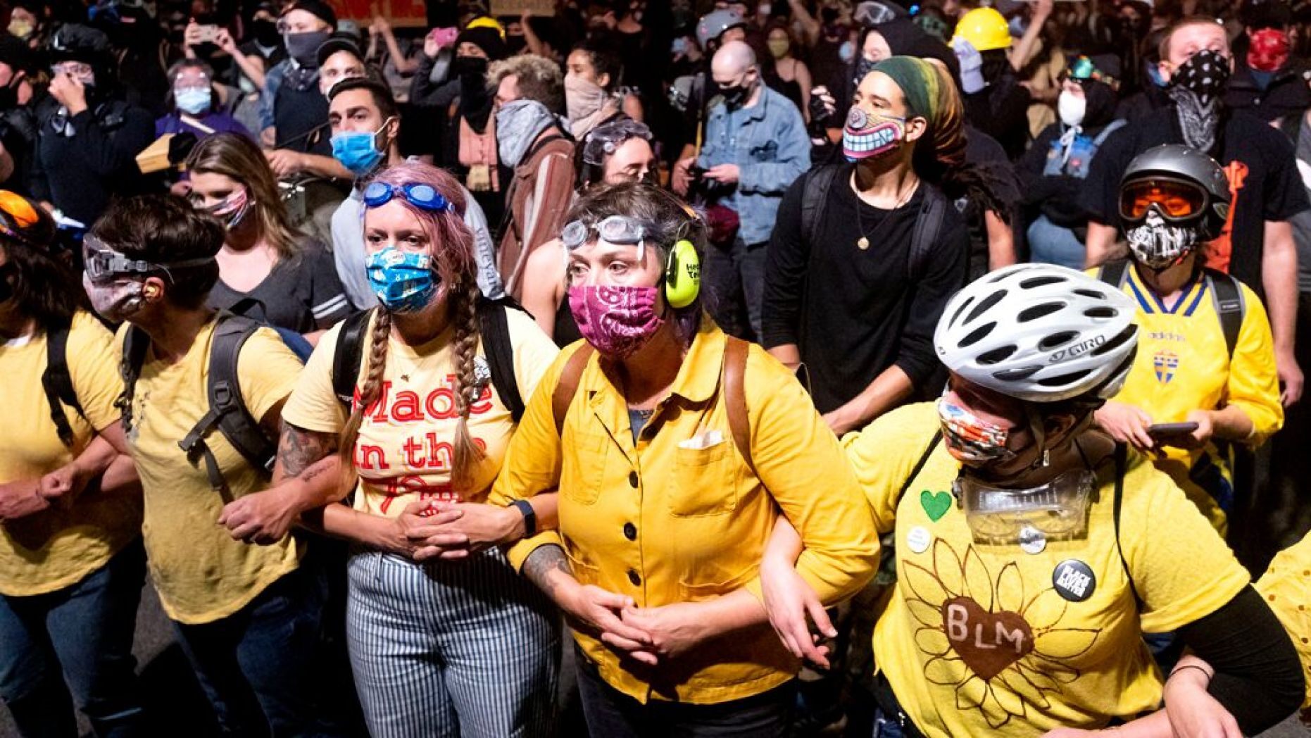 A group calling themselves the "Wall of Moms" gather outside the Mark O. Hatfield United States Courthouse Sunday in Portland, Oregon.
