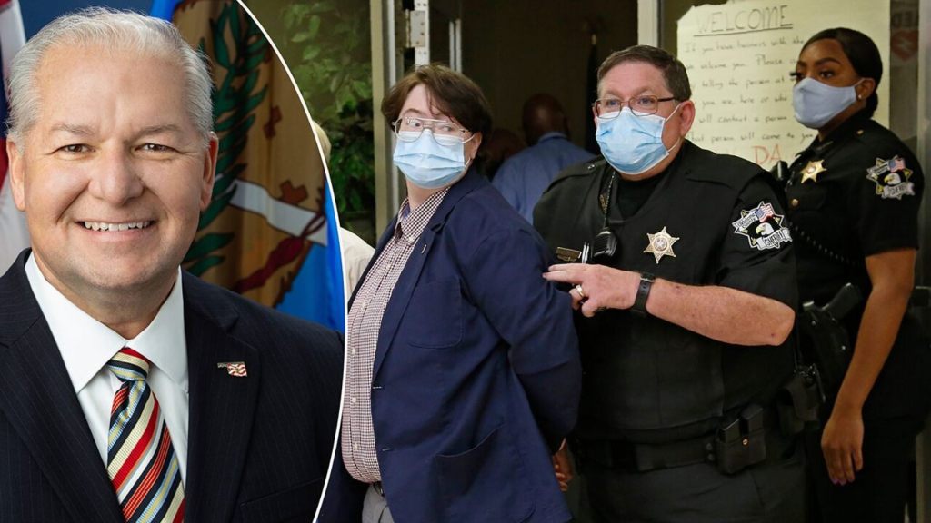 Protestors are escorted out of the office of Oklahoma County District Attorney David Prater in handcuffs at closing time, after staging a sit-in and refusing to leave, Monday, July 20,
