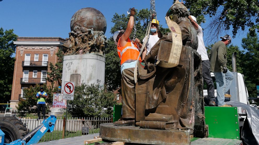 Workers remove the statue of Confederate Naval officer Matthew Fontaine Maury on Monument Avenue ,