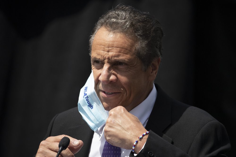 FILE - In this June 15, 2020, file photo, New York Gov. Andrew Cuomo removes a mask as he holds a news conference in Tarrytown, N.Y. New York’s ,