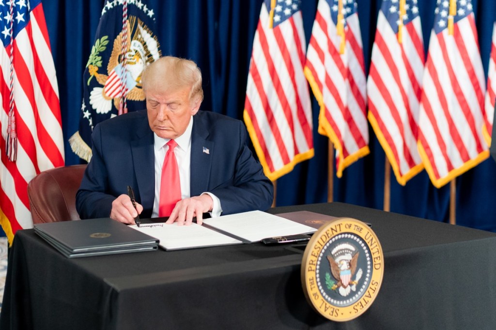 President Donald J. Trump signs a Presidential memorandum for continued student loan payment relief during the COVID-19 pandemic Saturday, Aug. 8, 2020, at a news conference in Bedminster, N.J.