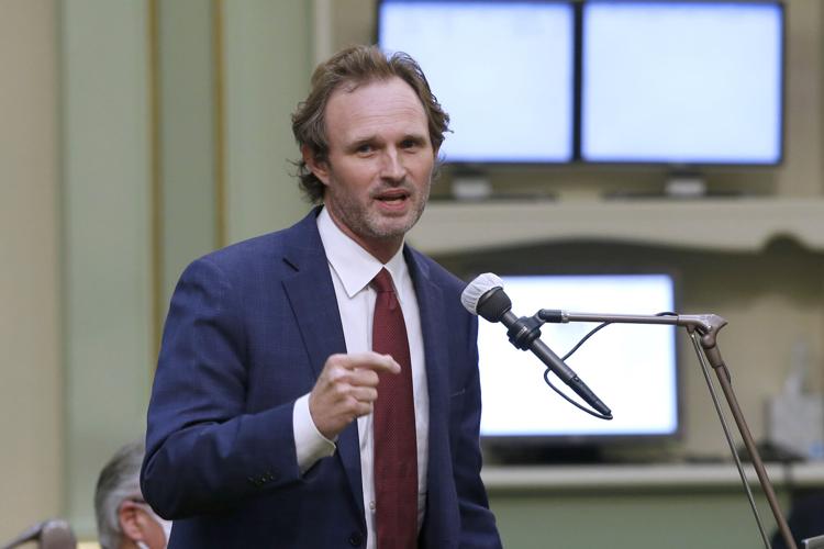 In this photo taken Monday, June 10, 2020, Assemblyman James Gallagher, R-Yuba City, left, speaks at the Capitol in Sacramento, Calif.