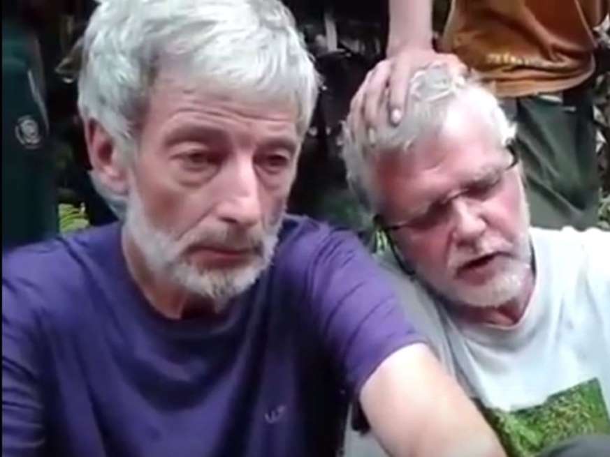 © YouTube Robert Hall, 50, (in purple on left) and John Ridsdel, 68, are seen in a hostage video.