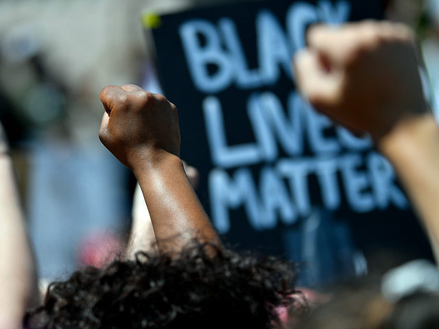 Fists were raised in memory of Breonna Taylor during a rally in her honor on the steps of the Kentucky State Capitol in Frankfort, Ky., Thursday, June 25, 2020.