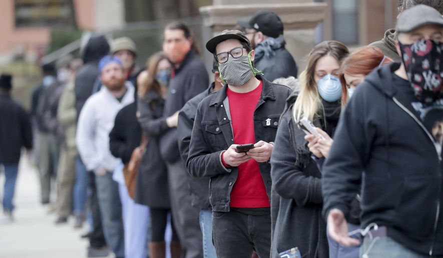 People line up to vote at Riverside High School during the primary in Milwaukee on Tuesday, April 7, 2020. Voters lined up to cast ballots across Wisconsin on Tuesday,