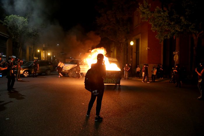 Portland Protesters set a dumpster on fire at the Multnomah Building in SE Portland on Aug. 18, 2020.