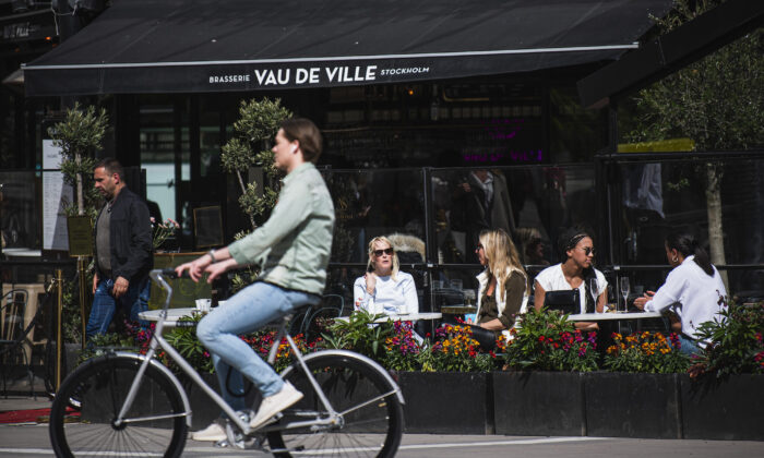 People sit in a restaurant in Stockholm, Sweden, on May 8, 2020. (Jonathan Nackstrand/AFP via Getty Images)