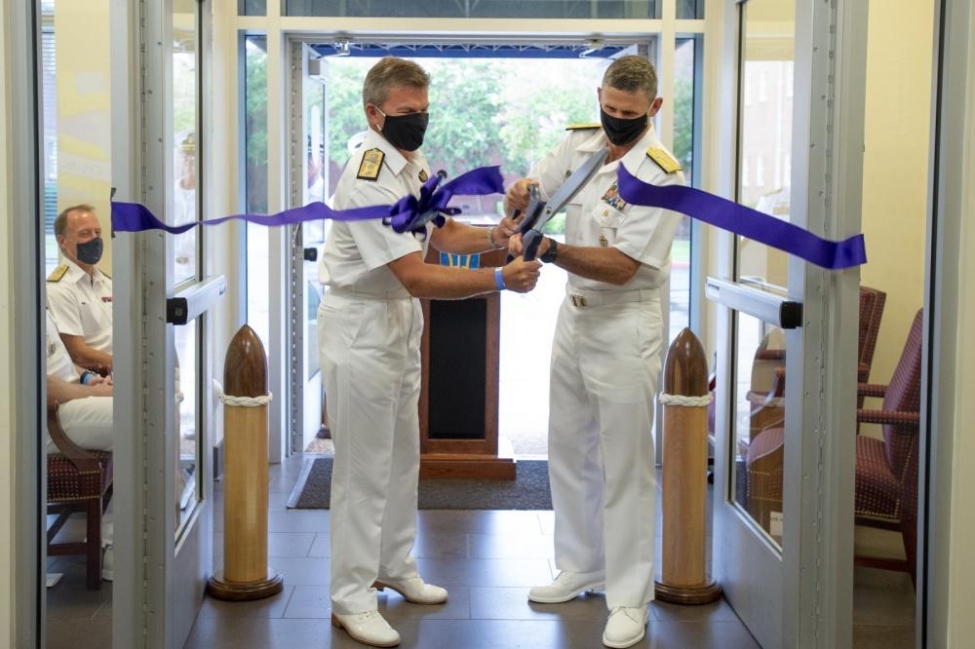 Royal Navy Rear Adm. Andrew Betton, deputy commander of Joint Force Command Norfolk, (left) and U.S. Vice Adm. Andrew Lewis, commander of the command, cut the ribbon during an Initial Operational Capability ceremony on Thursday.