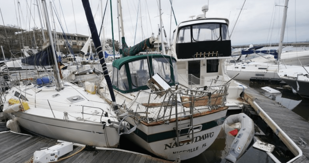 Storm damaged boats sit at the dock in a marina, Thursday, Sept. 17, 2020,