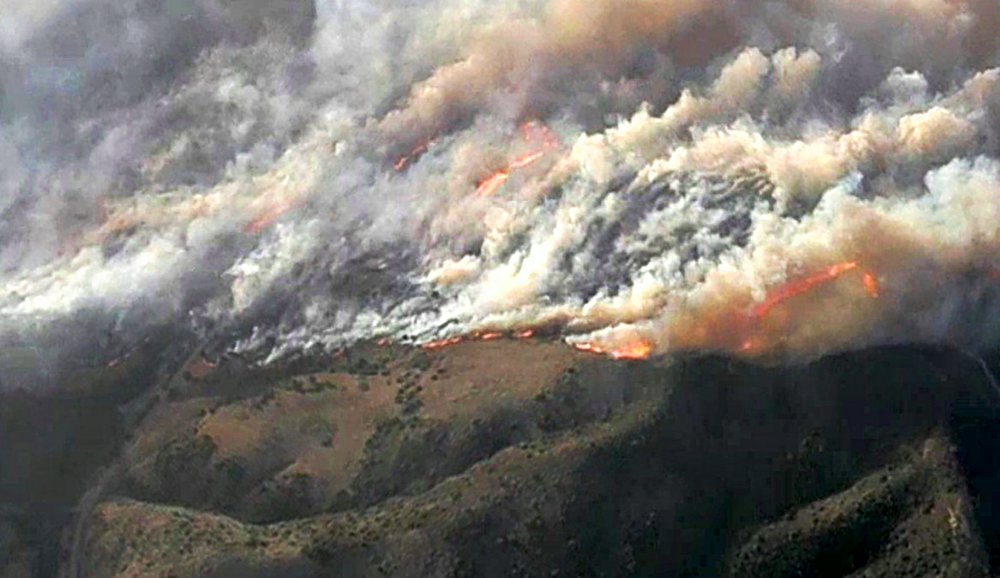 In this image from video provided by KNBC-TV, smoke and flames from the Silverado fire threatens areas near Irvine, Calif., Monday, Oct. 26, 2020.