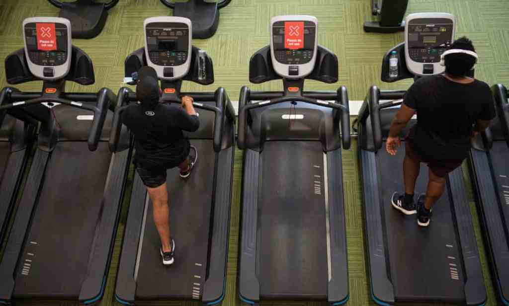 PureGym members exercise between ‘do not use’ machines at the branch in Leamington Spa, Warwickshire, central England.