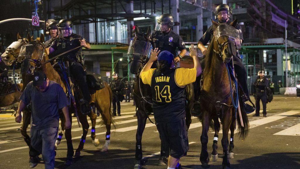 Police on horseback move people back as rowdy fans celebrate, Sunday, Oct. 11, 2020, in Los Angeles, after the Los Angeles Lakers defeated the Miami Heat in Game 6 of basketball's NBA Finals to win the championship.