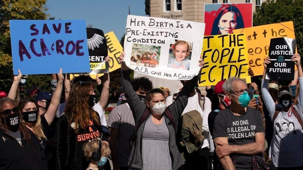 Protesters opposed to the confirmation of President Donald Trump's Supreme Court nominee Amy Coney Barrett, rally at the Supreme Court on Capitol Hill, in Washington, Wednesday, Oct. 14, 2020.