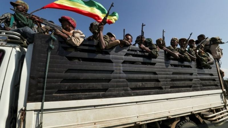 REUTERS image captionTroops loyal to the government ride in trucks to face Tigray People's Liberation Front forces.