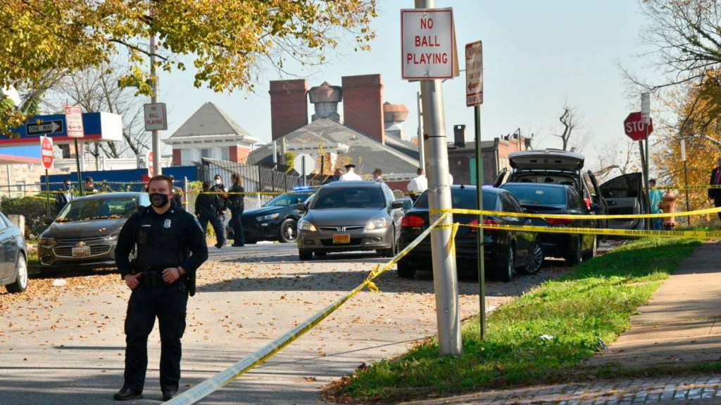 Baltimore police investigate the scene of a shooting in the city's Rosemont neighborhood Monday morning, Nov. 9, 2020.