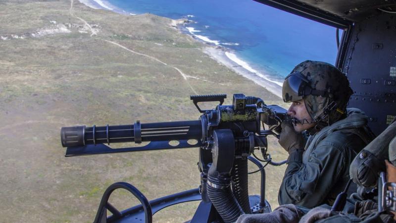 Sgt. Eric Landin, a crew chief with Marine Light Attack Helicopter Squadron 469, Marine Aircraft Group 39, 3rd Marine Aircraft Wing, fires a GAU-17 machine gun from a UH-1Y Venom helicopter during aerial gunnery training to meet annual qualifications over San Clemente Island, California, April 22, 2020.