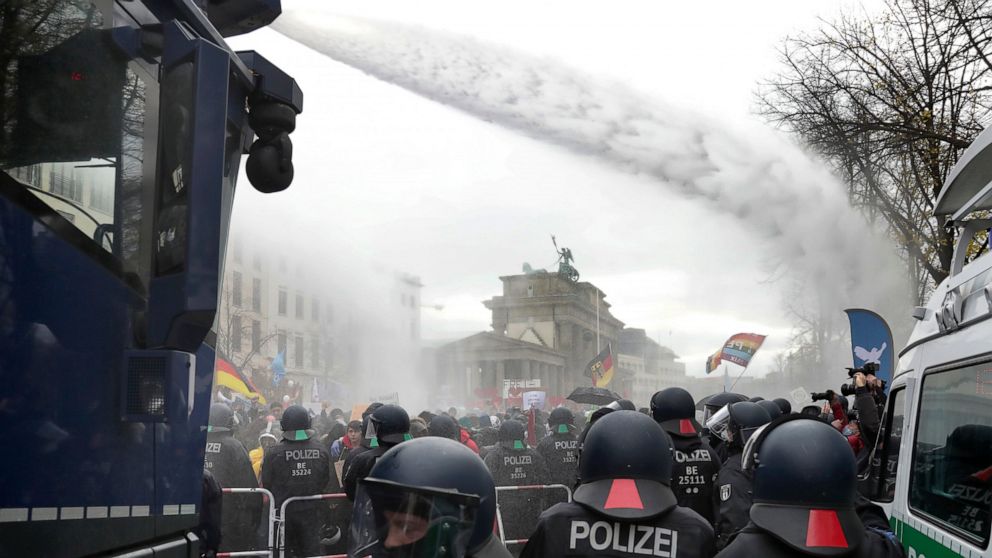 Police uses water canons to clear a blocked a road between the Brandenburg Gate and the Reichstag building, home of the German federal parliament,