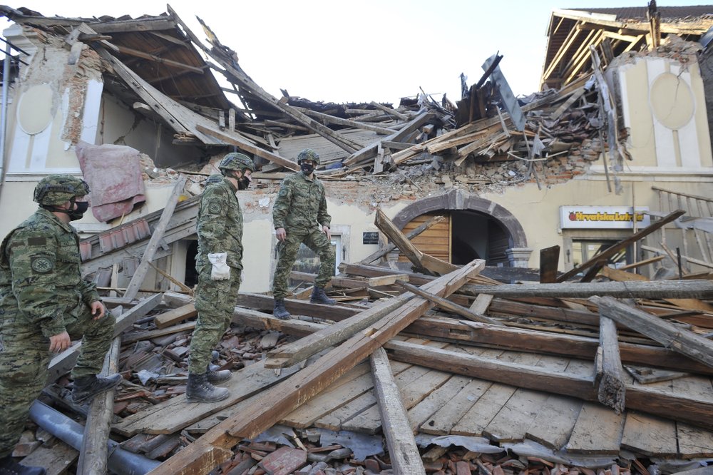 Soldiers inspect the remains of a building damaged in an earthquake, in Petrinja, Croatia, Tuesday, Dec. 29, 2020. A strong earthquake has hit central Croatia and caused major damage and at least one death in a town southeast of the capital.