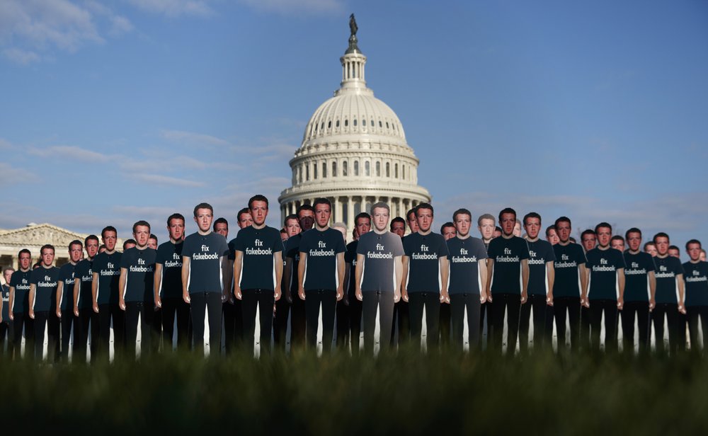 FILE - In this April 10, 2018, file photo, life-sized cutouts depicting Facebook CEO Mark Zuckerberg wearing "Fix Fakebook" T-shirts are displayed by advocacy group, Avaaz, on the South East Lawn of the Capitol on Capitol Hill in Washington, ahead of Zuckerberg's appearance before a Senate Judiciary and Commerce Committees joint hearing. Federal regulators asked Wednesday, Dec. 9, 2020,