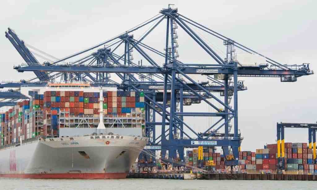 Shipping containers are unloaded from a cargo ship at the port of Felixstowe in Suffolk.