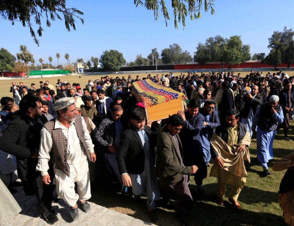Afghan men carry the coffin of journalist Malalai Maiwand, who was shot and killed on her way to work in Jalalabad, Afghanistan, on December 10, 2020.