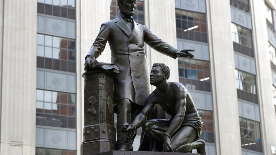 In this June 25, 2020, file photo, a statue that depicts a freed slave kneeling at President Abraham Lincoln’s feet rests on a pedestal in Boston. On Tuesday, Dec. 29, the statue that drew objections amid a national reckoning with racial injustice was removed from its perch.