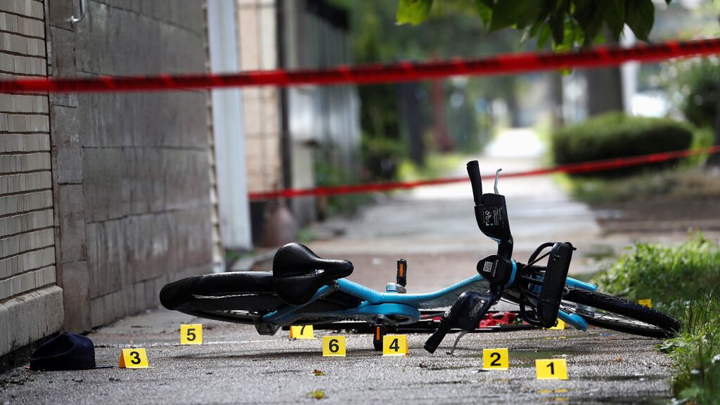 Shell casing markers are seen where a 37-year-old man riding a bicycle was shot and pronounced dead at the hospital, according to local media reports, on the West Side of Chicago, July 26, 2020.