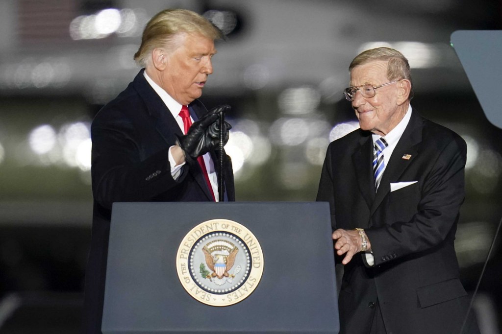 President Donald Trump, left, introduces former college football coach Lou Holtz during a campaign stop at the Butler County Regional Airport in Butler, Pa.