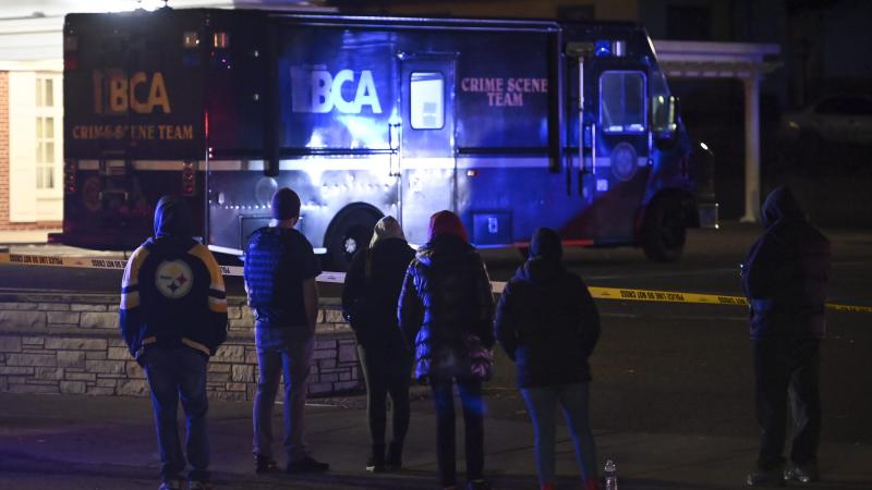 A crowd gathers on Sunday, Nov. 29, 2020, along Rice Street near the scene where St. Paul Police shot a man earlier in the night in St. Paul, Minn.