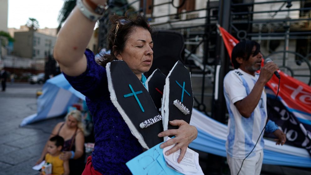 A demonstrator against abortion holds two fake coffins as she protests against the legalization of abortion, a day after President Alberto Fernández sent a bill to legalize abortion, outside Congress in Buenos Aires, Argentina, Wednesday, Nov. 18, 2020.