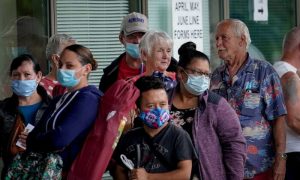People line up outside a Kentucky Career Center hoping to find assistance with their unemployment claim in Frankfort, Kentucky, on June 18, 2020.