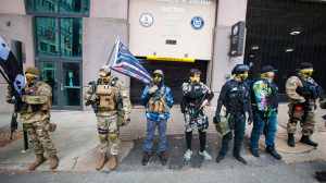 Boogaloo Bois stand on the sidewalk on 9th Street in support of lobby day on Monday, Jan. 18, 2021, in Richmond, Va. The day is a chance for citizens to use a day off work to meet with their legislators.