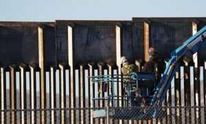 People work on the U.S.-Mexico border wall in El Paso, Texas, on Feb. 12, 2019.