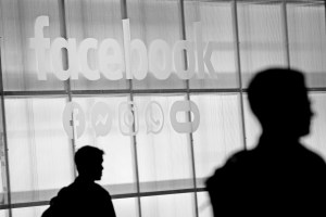 The Facebook logo is displayed during a conference. | Photo by Justin Sullivan/Getty Images