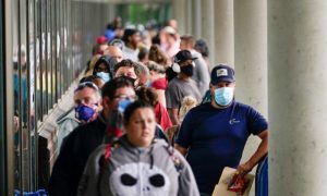 Hundreds of people line up outside a Kentucky Career Center hoping to find assistance with their unemployment claim in Frankfort, Ky., on June 18, 2020.