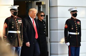 Then-President Donald Trump and First Lady Melania make their way to board Marine One before departing from the South Lawn of the White House in Washington on Jan. 20, 2021.