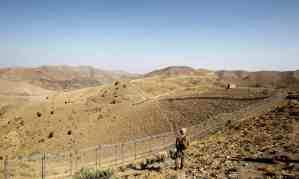 A Pakistani soldier stands guard along the border fence with Afghanistan in North Waziristan. Militants have in recent months stepped up their activities in the region.