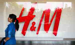 A passerby outside the first H&M to open in India, in New Delhi.