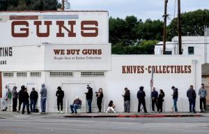 In this March 15, 2020, file photo, people wait in line to enter a gun store in Culver City, Calif.