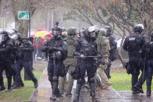 Officers with the Salem Police Department and the Marion County Sheriff's department separate a group of Trump supporters and counter-protesters gathered at the Oregon state capitol building on January 6, 2021, following a rally of some 250 Trump supporters who gathered to protest the 2020 presidential election results.
