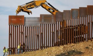 A construction crew installs new sections of the U.S.-Mexico border barrier as seen from Tijuana, Mexico on Jan. 11, 2019.