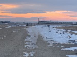 One guard sits outside a workforce camp one mile north of Philip, South Dakota. The workforce camps, also known as "man camps,"