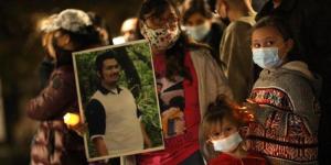 Family and community members hold a candlelight vigil for victims of violent crime at the Hall of Justice in downtown Los Angeles on Dec. 31, 2020.  (Genaro Molina / Los Angeles Times via Getty Images)
