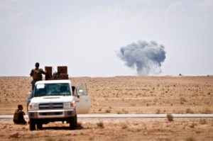 Syrian Democratic Forces watch as a coalition airstrike hits ISIS target near the Iraq-Syria border, May 13, 2018.